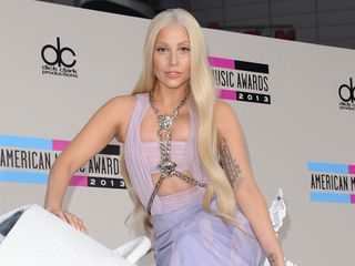 Lady Gaga wears a lilac Versace gown as she rides into the AMA's on a white horse