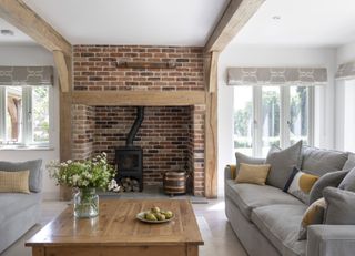 an oak frame home with a brick fireplace