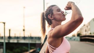 Woman drinking after hard workout
