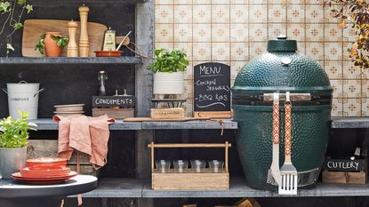 outdoor kitchen with Big Green BBQ, tiled walls, storage, shelves, condiments, glassware, low table, storage for cutlery, compost, logs