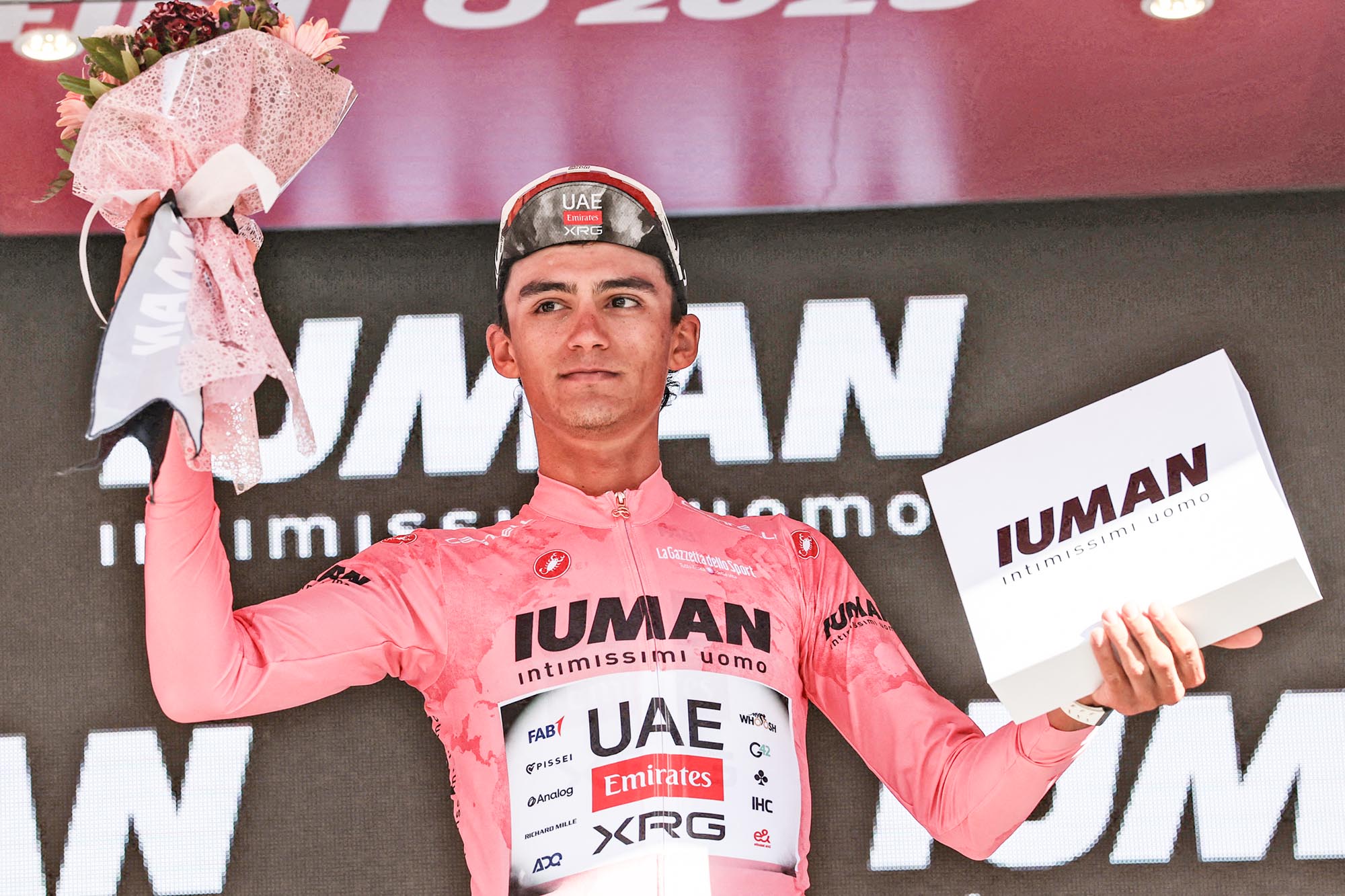 UAE Team Emirates XRG's Mexican rider Isaac Del Toro celebrates with the pink jersey of overall leader on the podium of the 9th stage of the 108th Giro d'Italia cycling race of 181kms from Gubbio to Siena on May 18, 2025. (Photo by Luca Bettini / AFP) (Photo by LUCA BETTINI/AFP via Getty Images)