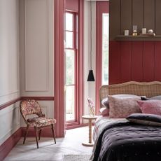 bedroom with white walls and pink skirting boards and wood work