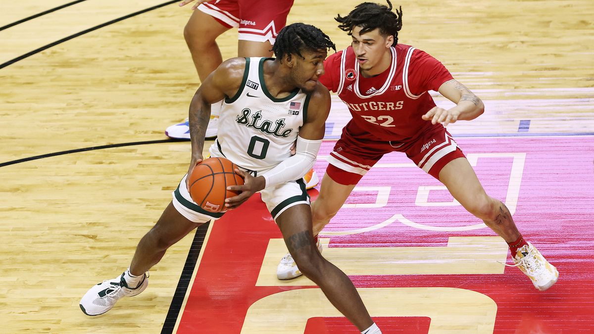 Aaron Henry #0 of the Michigan State Spartans in action against Caleb McConnell #22 of the Rutgers Scarlet Knights during an NCAA college basketball game at Rutgers Athletic Center on Jan. 28, 2021 in Piscataway, New Jersey.