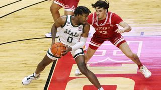 Aaron Henry #0 of the Michigan State Spartans in action against Caleb McConnell #22 of the Rutgers Scarlet Knights during an NCAA college basketball game at Rutgers Athletic Center on Jan. 28, 2021 in Piscataway, New Jersey.