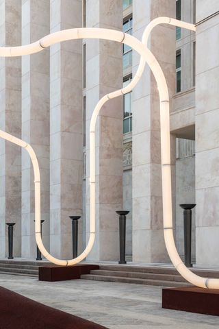 Sinuous light installation by Objects of Common Interest in front of building in Bergamo