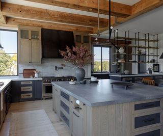 Industrial style kitchen with wooden beams and wooden cabinets with steel countertops