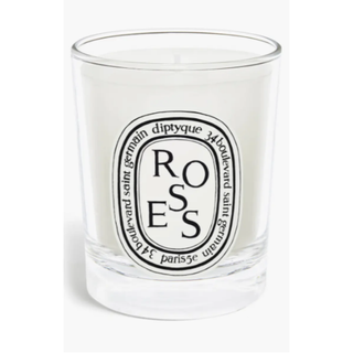 rose-scented white candle in a glass jar