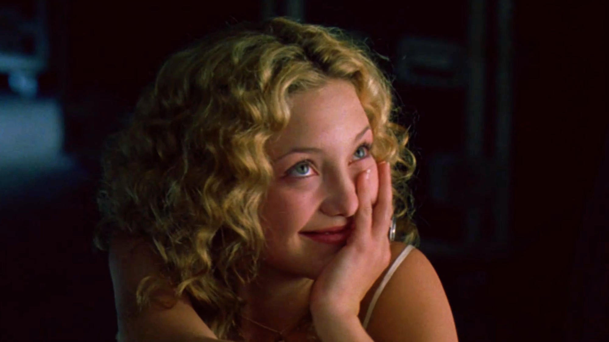 Kate Hudson with curly hair and her hand over her mouth in Almost Famous