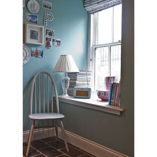 dix blue wall chair window with books and radio