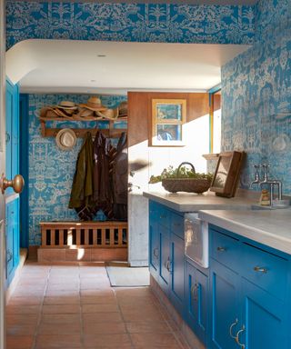 A colorful boot room in a country home in Sussex designed by Kate Forman