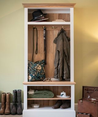 small painted hallway closet storage with hooks