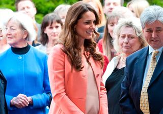 Kate Middleton wearing a peach dress and coat