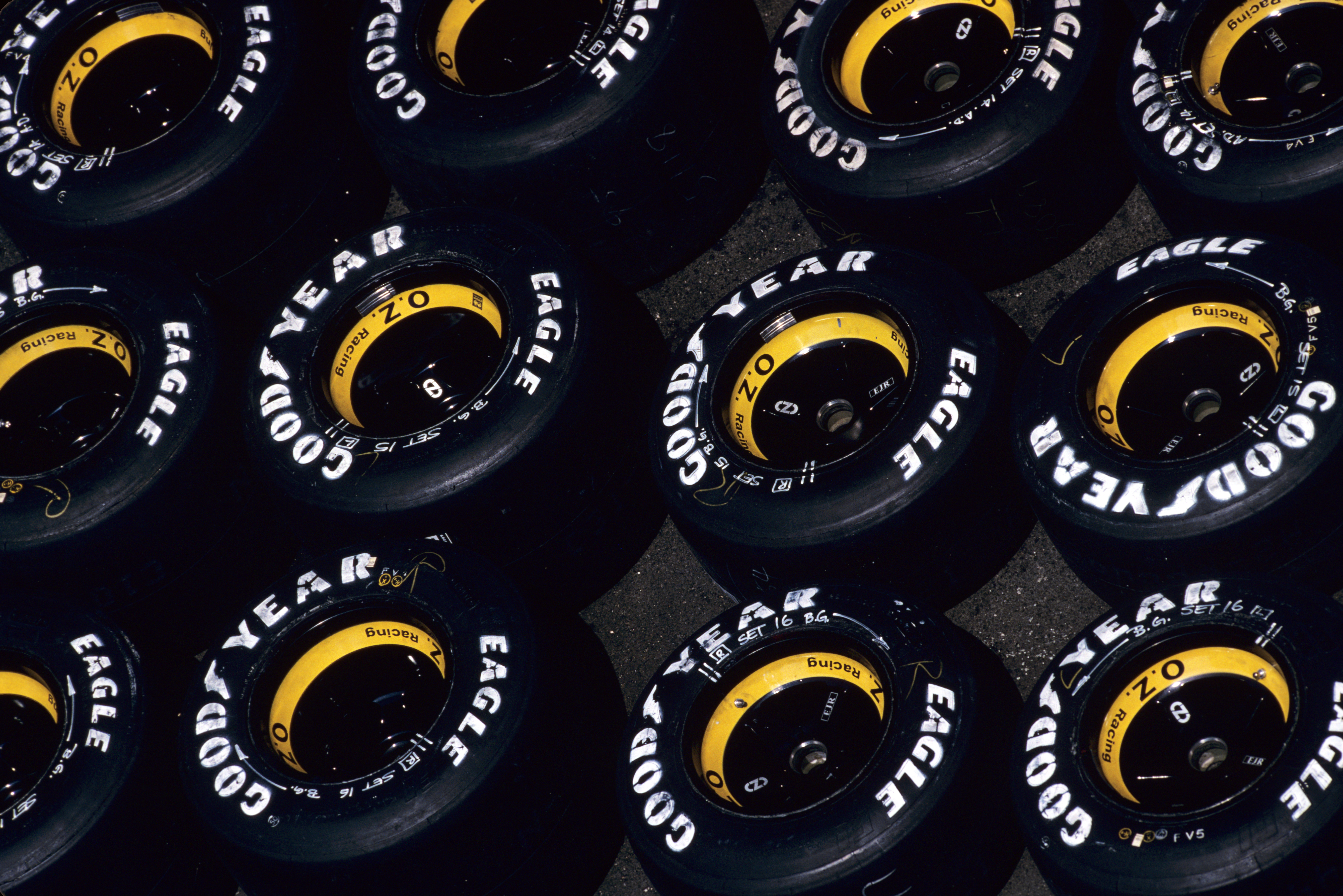 Multiple Goodyear F1 tyres mounted to yellow wheels