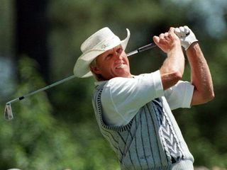 Greg Norman hits an iron shot during the 1996 Masters