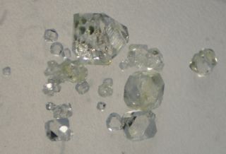 Synthetic crystals of the calcium phosphate mineral whitlockite similar to those used to produce the extraterrestrial mineral merrillite. If life ever arose on Mars, merrillite may have been a major source of biologically required phosphate. Largest crystal are ~1mm.