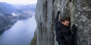 Tom Cruise clinging to a wall