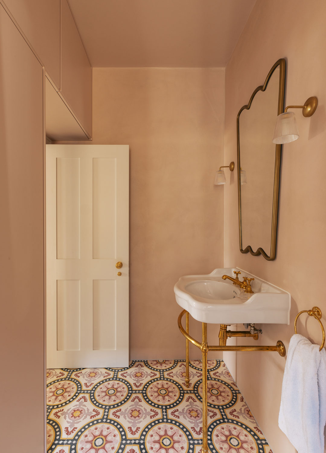 pink bathroom with pink and green patterned floor tiles