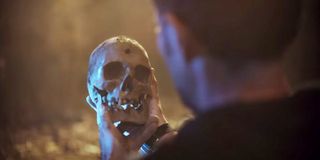 Manolo Cardona holding a skull in Who Killed Sara
