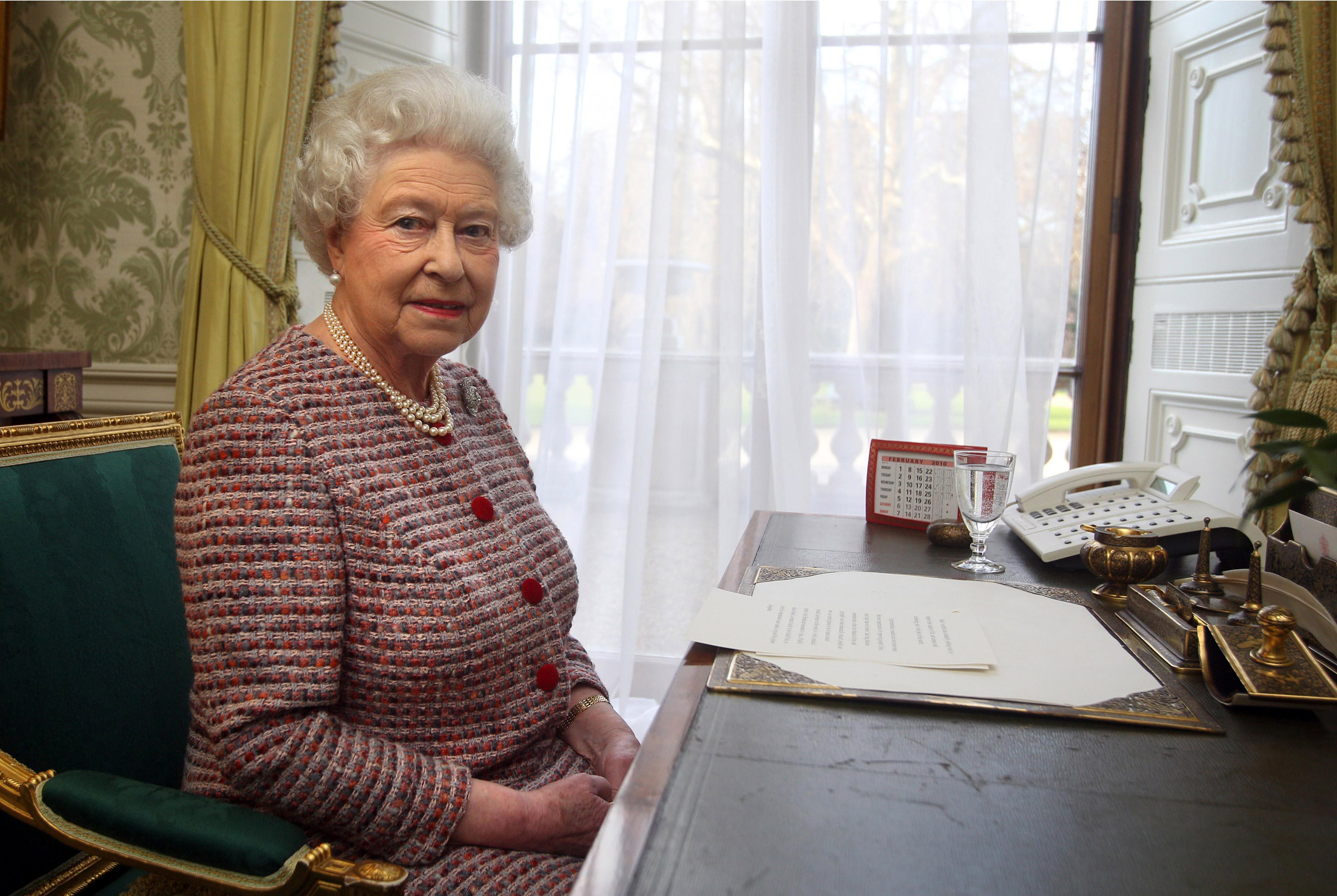 Queen Elizabeth sitting at a desk