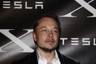 A photograph of Elon Musk at a public event