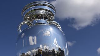 Close up of the UEFA European Championship trophy against a blue sky