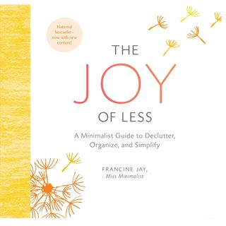 the front cover of joy of less book by francine jay with orange and gray writing and seeds of a dandelion blowing away