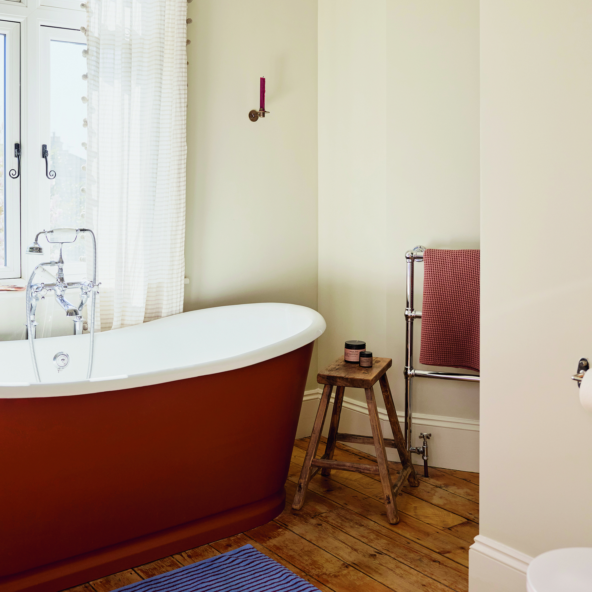 simple neutral bathroom with terracotta bath