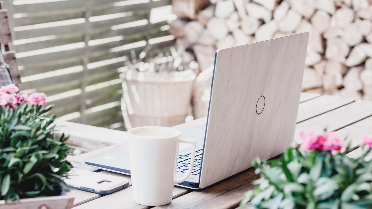 Working from home with a laptop on a garden table 