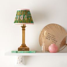 Freya rechargeable table lamp displayed on shelf with surrounding home decor
