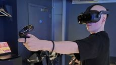 Hamish Hector using the Vive Focus Vision, he has his controller raised up.