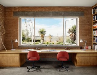 study with picture window looking to nature at house in Marfa