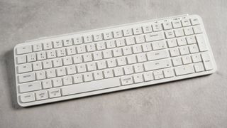Keychron B2 Pro ultra-slim low profile keyboard in white photographed on a grey background.