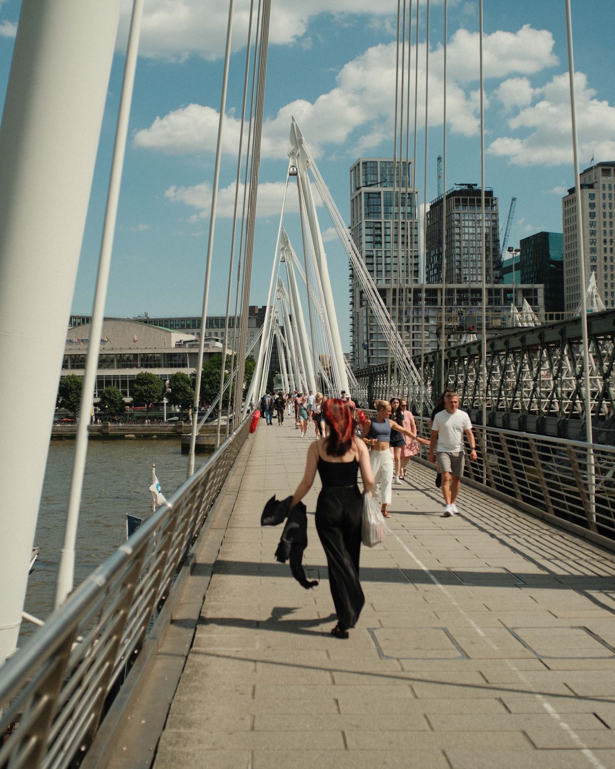 Bridge crossing the River Thames with people crossing
