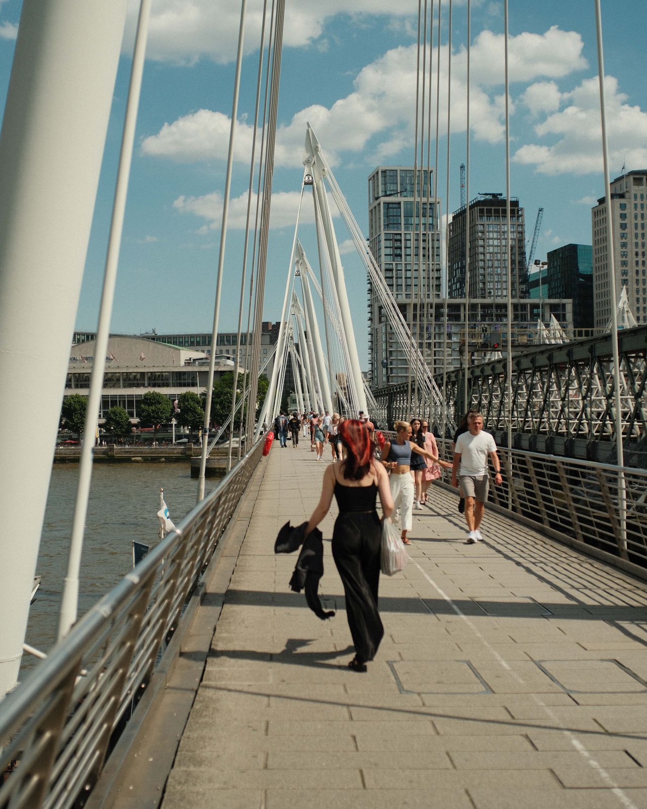 Bridge crossing the River Thames with people crossing