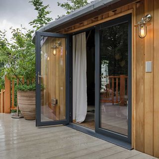 grey aluminium French doors leading to decking