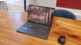 The Acer Chromebook 516 GE open on a desk with a gaming mouse.