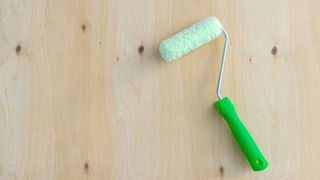 Paint roller on plywood sheet