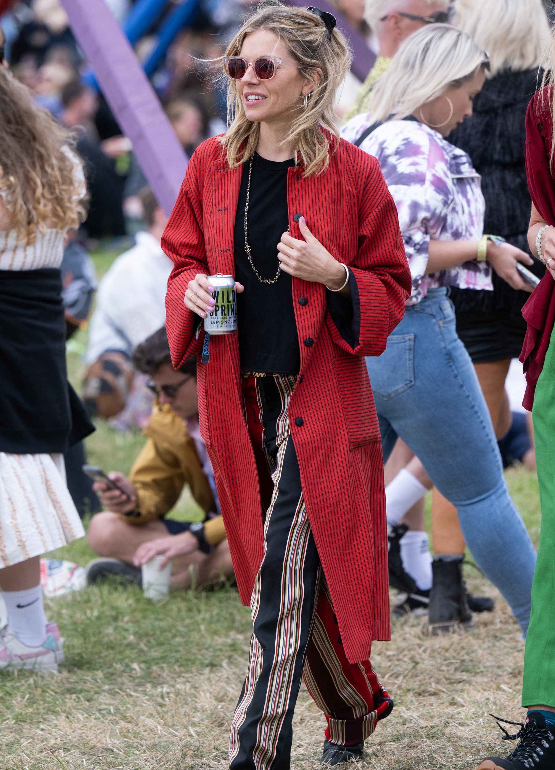 Sienna Miller wearing red jacket