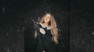 Photographer Rosie Hardy specializes in self-portraits with an ethereal twist. Here she can be seen on a black background with shards of glass flying about her.