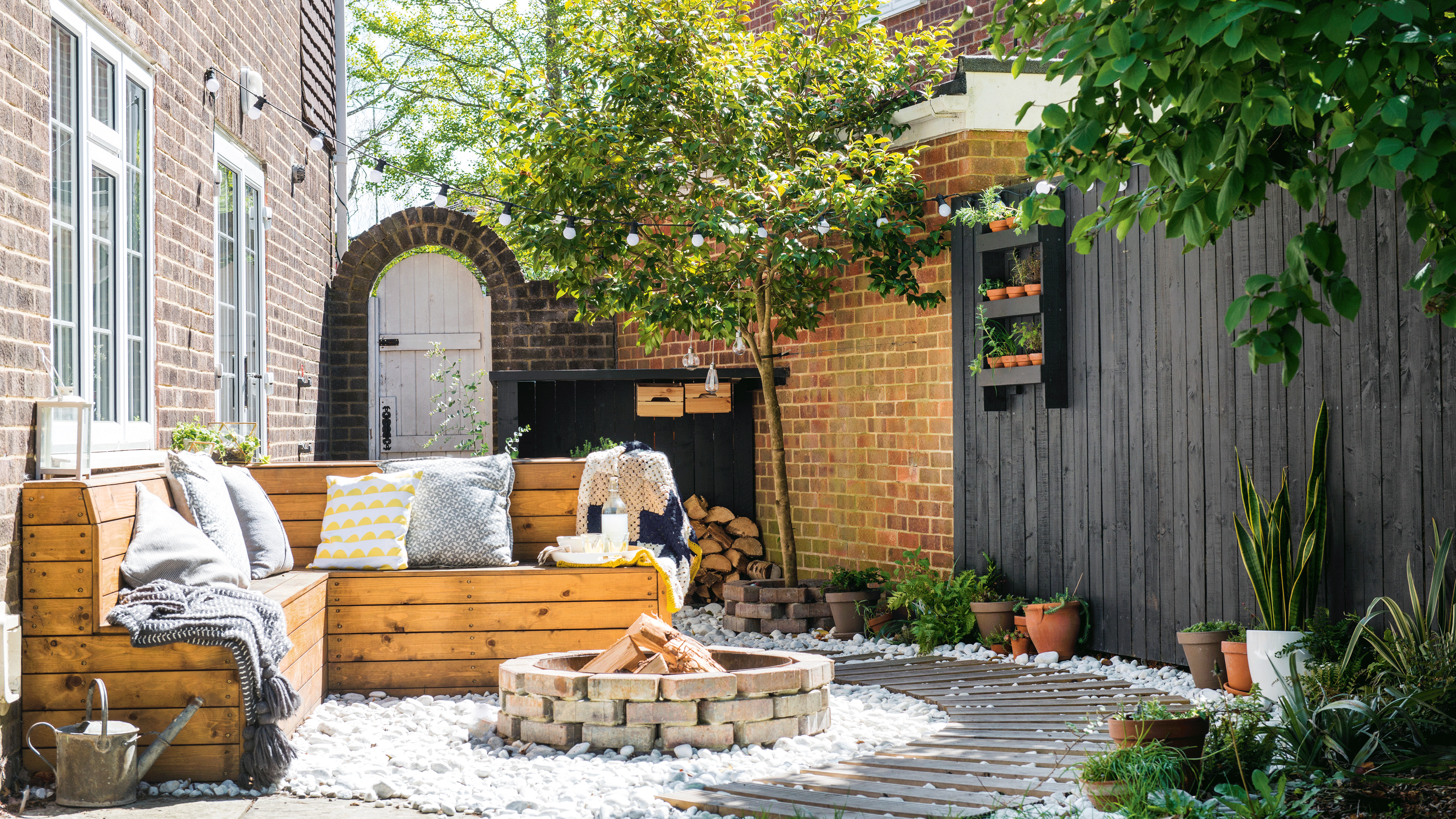 garden with outdoor living area, furniture made from pallets, shed in background