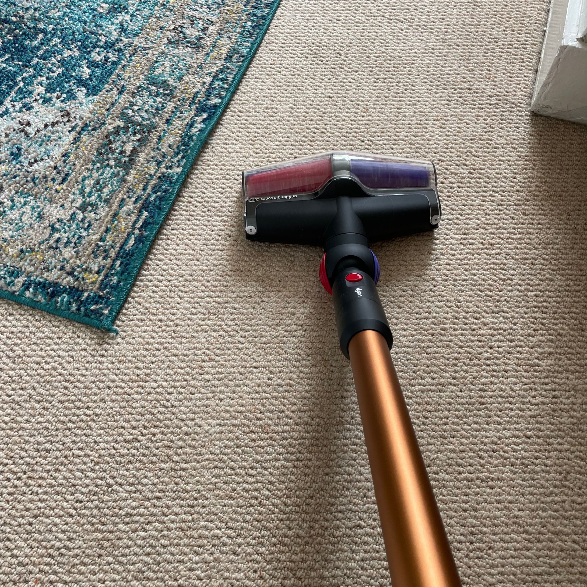 Using the Dyson V16 Piston Animal on a cream wool carpet