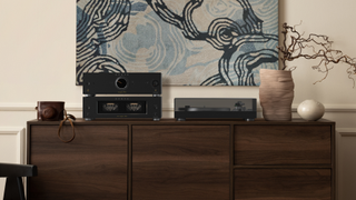 Onkyo Icon P-80 and M-80 amps on a wooden sideboard with turntable and art