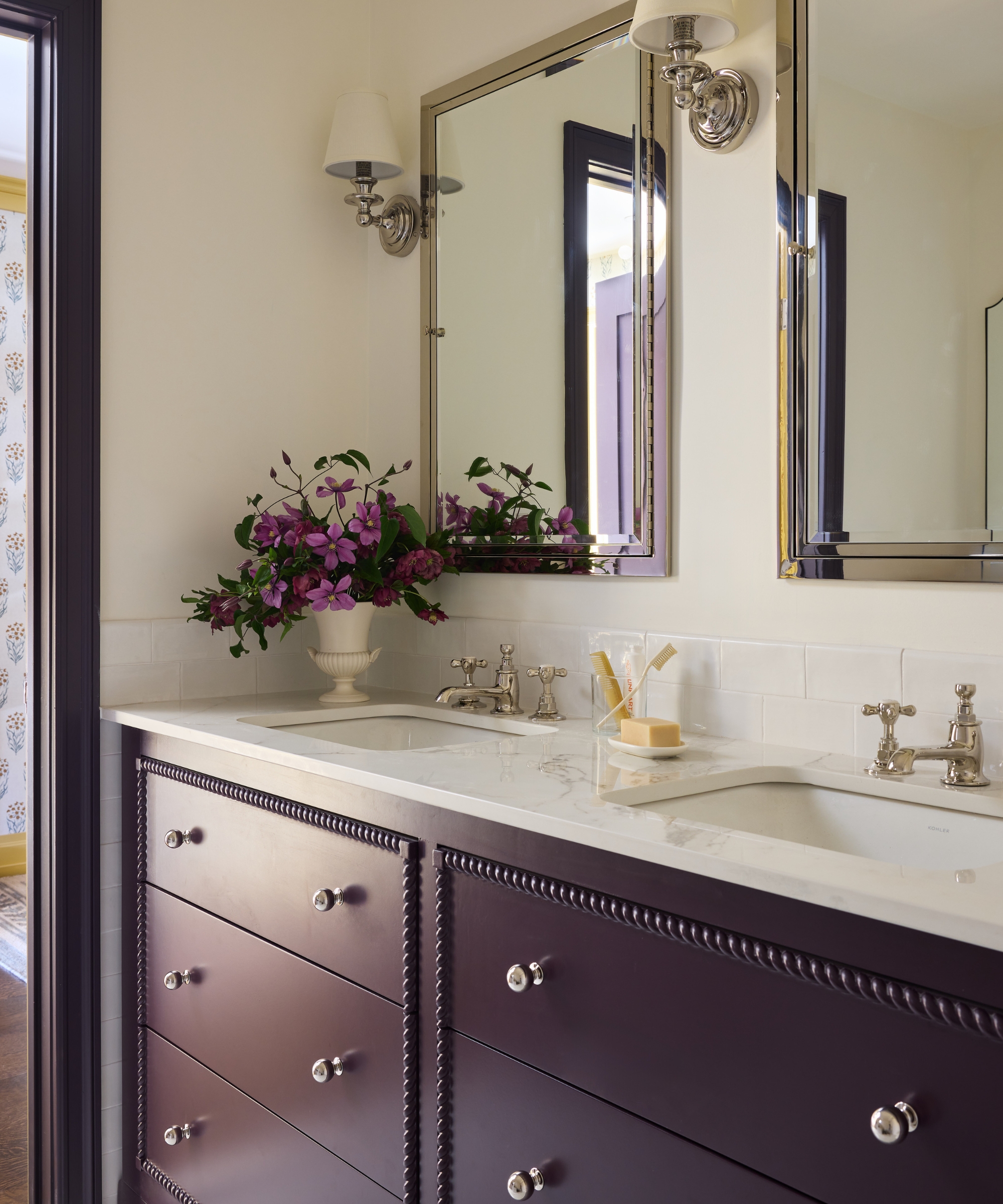 Primary bathroom with plum rope-trim vanity, marble countertop, mirrored cabinets and green mosaic floor tiles.