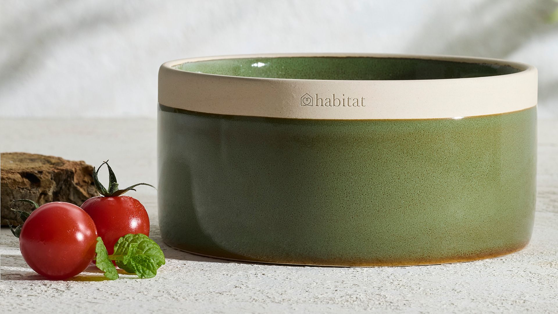 A green ceramic tomato leaf scented candle from Habitat