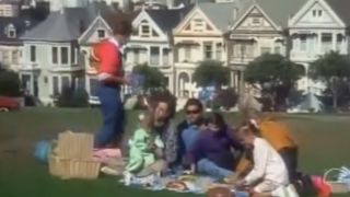 A shot of the cast of Full House in a park in front of the Painted Ladies in San Francisco