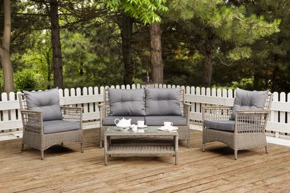decking railing ideas: outdoor seating surrounded by white deck fence