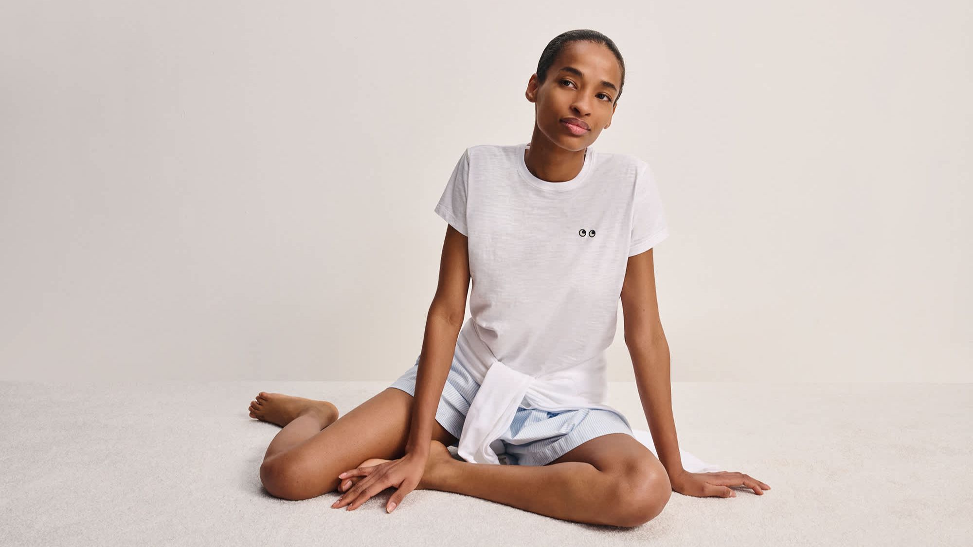a model wearing a tshirt from the uniqlo x anya hindmarch collection