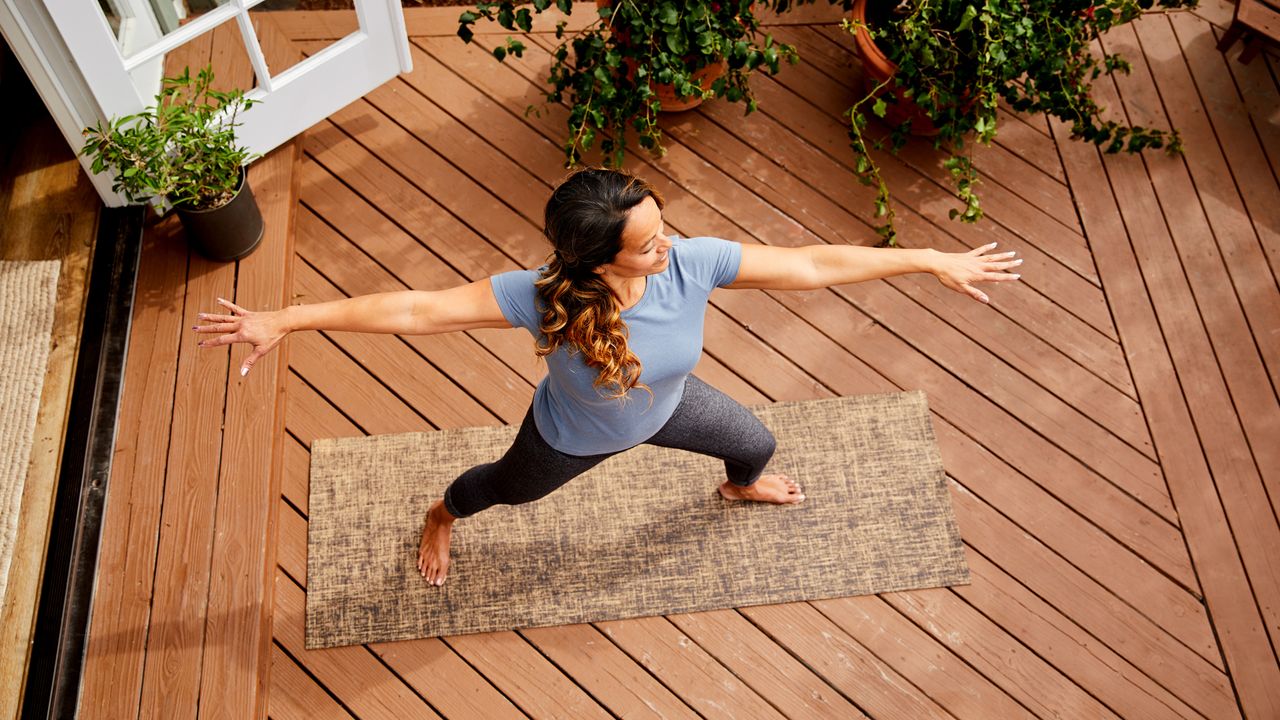 Woman taking a yoga class at home