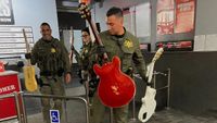 Police officers holding various guitars