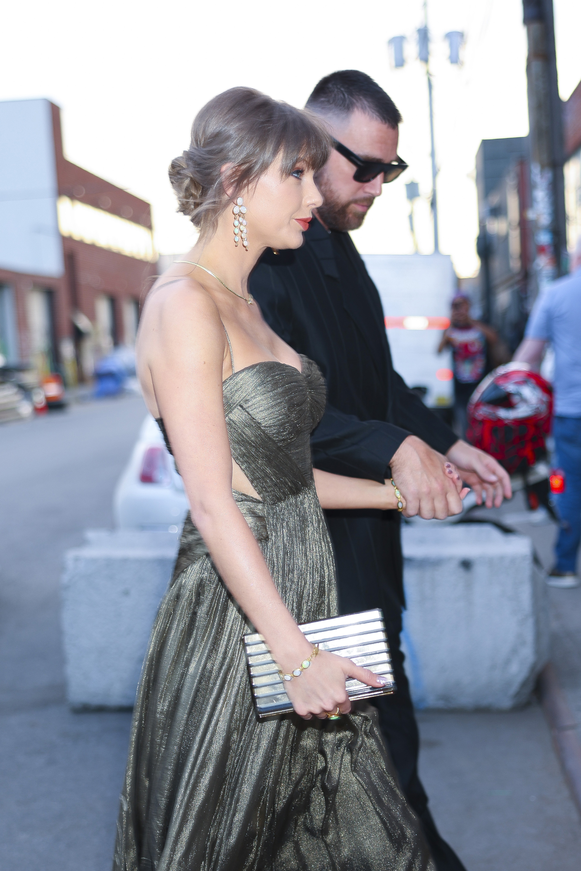 Taylor Swift wears a gold gown and sparkling shoes with Elizabeth Taylor's opal jewelry set